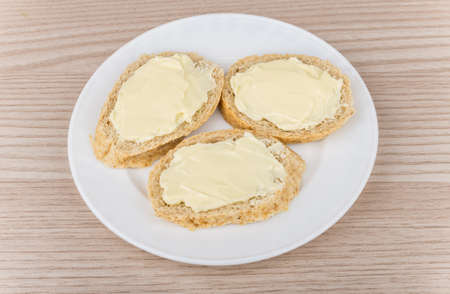 Three of butter in glass white plate on table