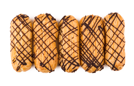 Row of five eclairs isolated on white background