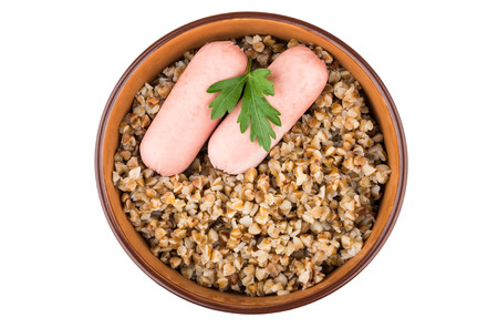 Cooked buckwheat and sausages in ceramic bowl isolated on white background, top viewの写真素材