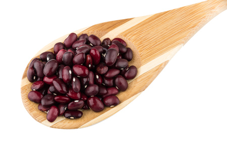 Raw red beans in bamboo spoon isolated on white background