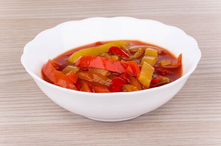 Lecho of bell pepper in glass bowl on tableの写真素材