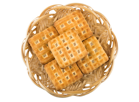 Wicker basket with biscuits sandwiches isolated on white background, top viewの写真素材