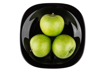 Three gren apples in black plate isolated on white background, top viewの写真素材