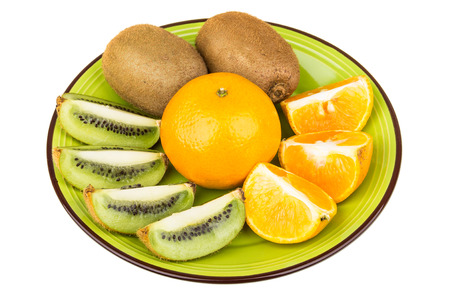 Slices of various fruits in green plate isolated on white backgroundの写真素材