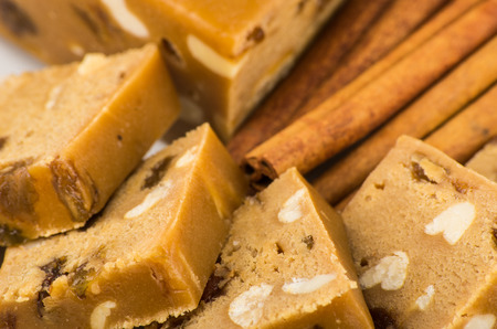 Pieces of sherbet with peanut and raisins, cinnamon sticks close upの写真素材