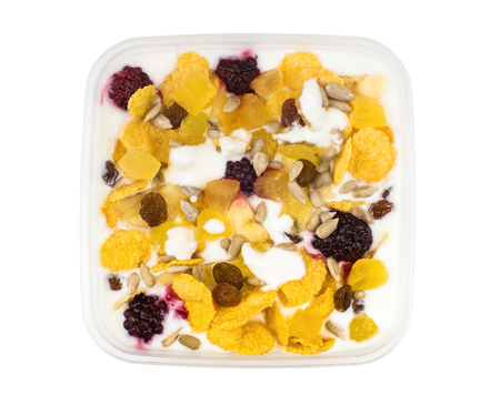 Muesli with pineapple, raisins, raspberry, dried apricots and yogurt isolated on white background....