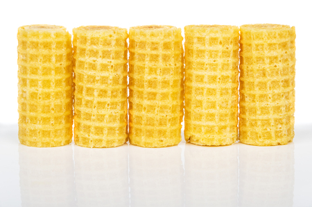 Row of wafer rolls with reflection isolated on white backgroundの写真素材
