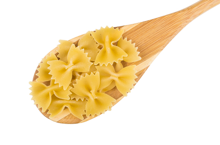 Macaroni farfalle in wooden spoon isolated on white backgroundの写真素材