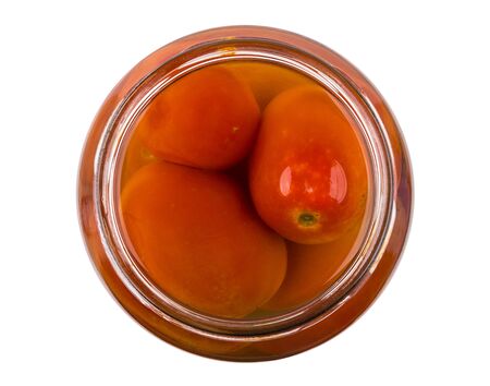 Open jar with red pickled tomatoes isolated on white background. Top viewの写真素材