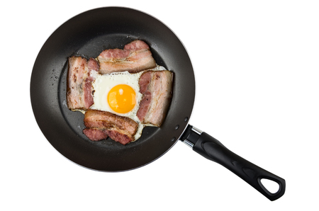 Frying pan with prepared bacon and fried eggs isolated on white background. Top viewの写真素材