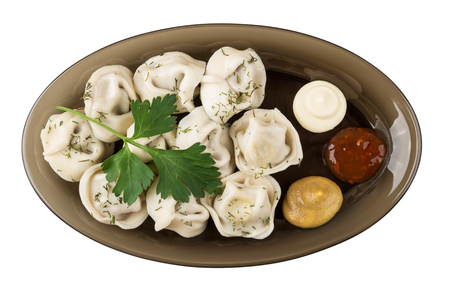 Boiled dumplings with mayonnaise, mustard, ketchup and parsley in dish isolated on white background. Top viewの写真素材
