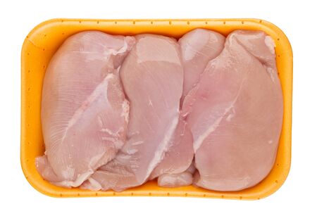 Plastic tray with chicken breast fillet isolated on white background. Top viewの写真素材