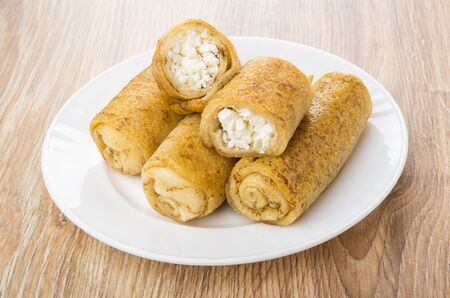 Fried pancake with cottage cheese in plate on wooden tableの写真素材