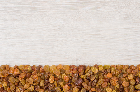 Stripe of raisins in bottom wooden table. Top viewの写真素材