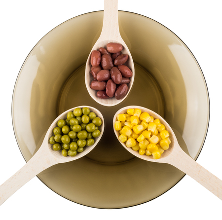 Red beans, green peas, sweet corn in wooden spoons in plate isolated on white background. Top viewの写真素材
