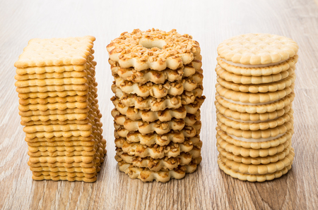 Three stacks with different cookies on wooden tableの写真素材
