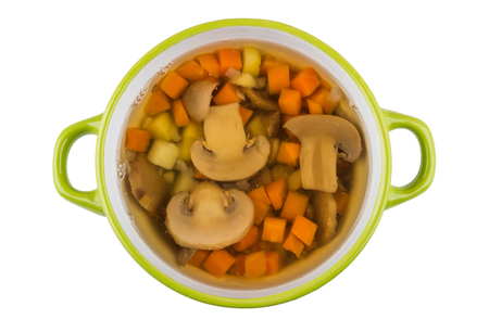 Vegetable soup with mushrooms in green bowl isolated on white background. Top viewの写真素材