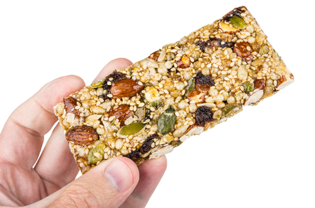 Kozinak with almonds and raisins in male hand isolated on white backgroundの写真素材