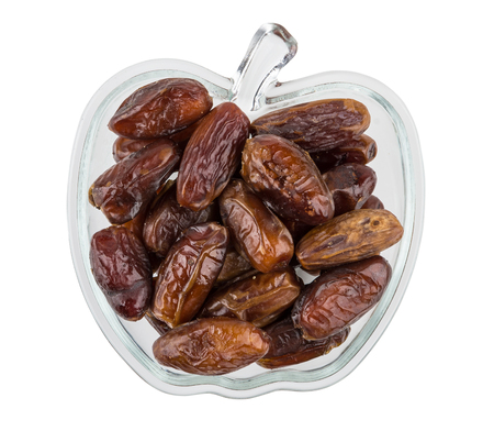 Glass bowl with dates (tropical fruits) isolated on white background. Top viewの写真素材