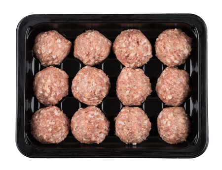 Plastic container with raw meatballs isolated on white background. Top viewの写真素材