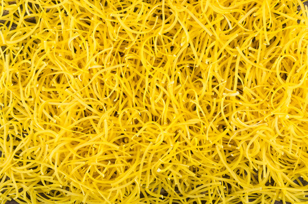 Background from heap of thin noodles on table. Top view
