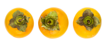 Three ripe persimmons isolated on white backgroundの写真素材
