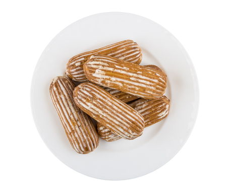 Glazed gingerbreads in glass plate isolated on white background. Top view