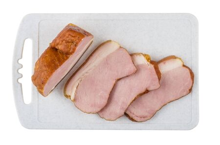 Slices of smoked gammon on cutting board isolated on white background. Top viewの写真素材