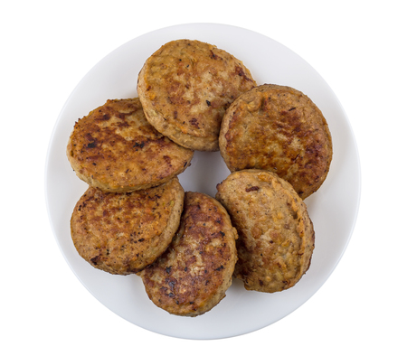 Fried cutlets in white plate isolated on white background. Top viewの写真素材