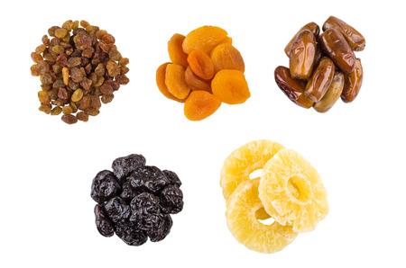 Heaps of prunes, dried apricots, raisins, dried apricots and dates isolated on white background. Top viewの写真素材