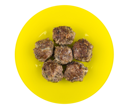 Fried beef meatballs in yellow plate isolated on white background. Top viewの写真素材