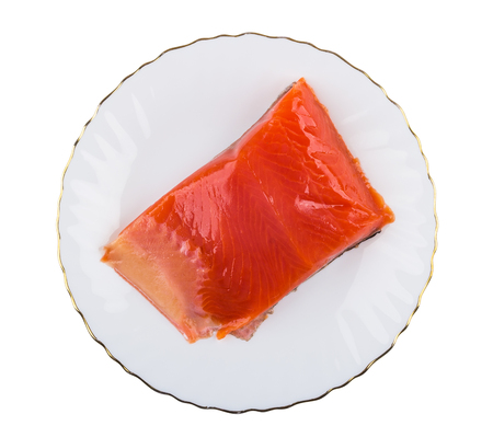 Piece of salted salmon in glass plate isolated on white background. Top viewの写真素材