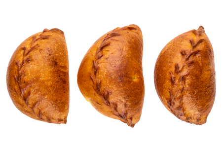 Three small pies with stuffing isolated on white background. Top viewの写真素材