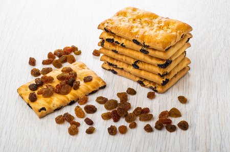 Stack of cookies with raisin, scattered raisin on cookie on wooden tableの写真素材