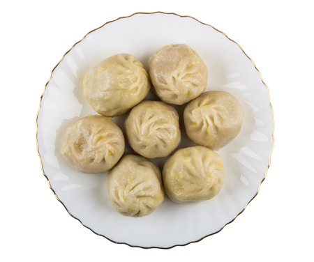Boiled khinkali in glass plate isolated on white background. Top viewの写真素材