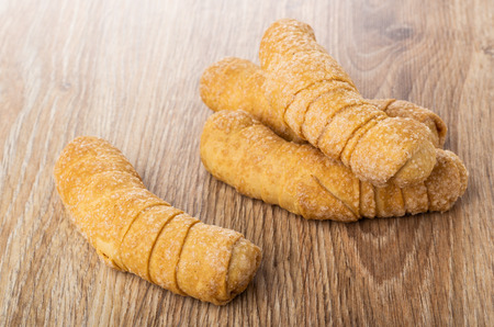 Few small croissants in sugar on wooden tableの写真素材