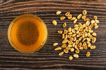 Bowl with honey, scattered puffed wheat on dark wooden table. Top viewの写真素材