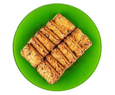 Shortbread cookies with filling from jam in green plate isolated on white background. Top viewの写真素材