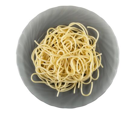 Cooked spaghetti in grey glass plate isolated on white background. Top viewの写真素材