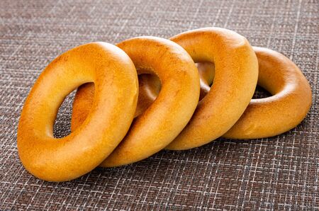Few yellow baked bread rings brown matの写真素材