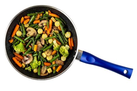 Fried spanish vegetable mix in frying pan isolated on white background. Top viewの写真素材