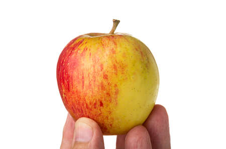 Red striped apple supported on fingers of man isolated on white background
