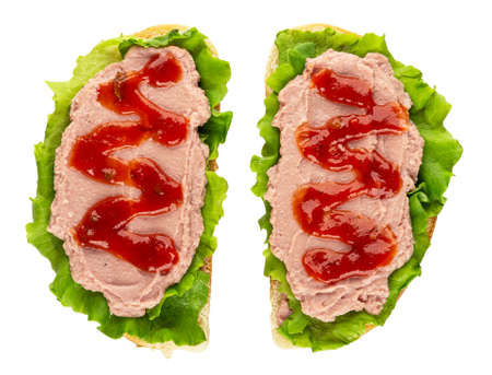 Two sandwiches with meat pate, ketchup and leaves of lettuce isolated on white background. Top viewの写真素材