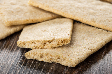 Close up of crispbreads on dark wooden table