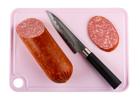 Piece of cervelat, kitchen knife, slice of sausage on pink cutting board isolated on white background. Top viewの写真素材