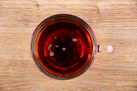 Transparent glass cup with russian kvass on wooden table. Top viewの写真素材