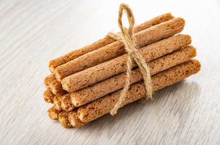 Bunch of brown sticks with cream filling on wooden tableの写真素材