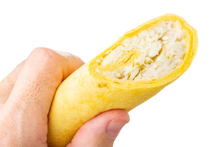 Tortilla with caesar salad in male hand isolated on white background