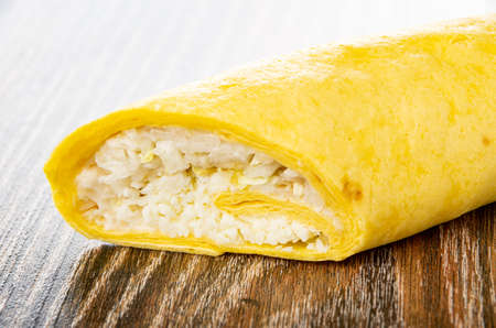 Tortilla with caesar salad on dark wooden tableの写真素材