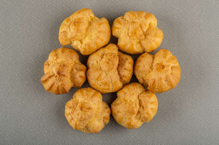 Few profiteroles with whipped cream on gray table. Top viewの写真素材